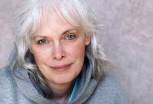 img-blog-Casual portrait of happy mature woman with natural white hair and minimal makeup