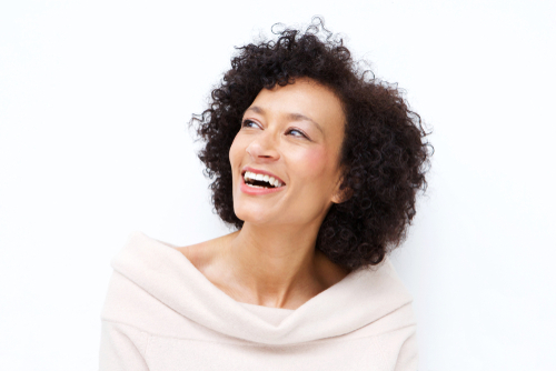 close up portrait of attractive middle age african american woman laughing against white background-img-blog