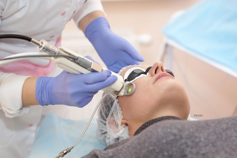 Woman undergoing a laser treatment on her cheek.